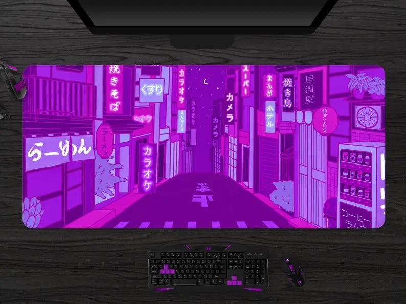 Purple illustrated desk mat shown on a desk with computer accessories