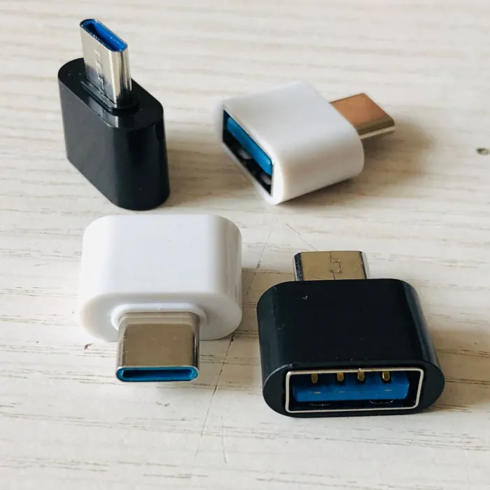USB-C to USB-A adapters shown in black and white from several angles